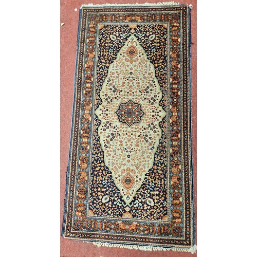 748 - A Cream and Brown ground Rug.
L 160 x 76 cm approx.