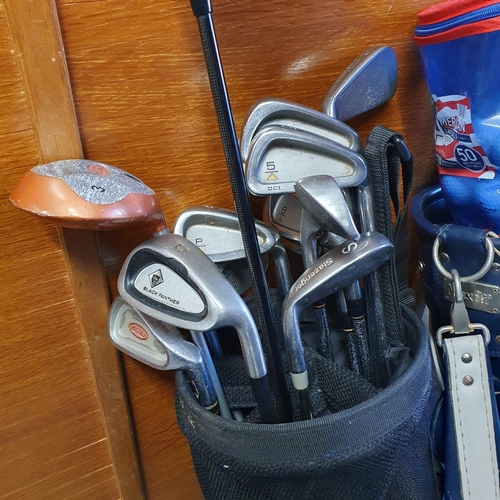 769 - Two Golf Caddy bags with twelve Golf Clubs, a quantity of Golf Balls and a set of hand dumbbell weig... 