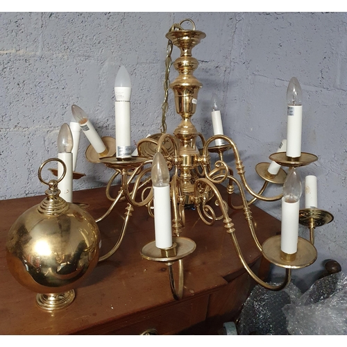 772 - A twelve branch Brass Chandelier. L 90 x D 80 cm approx.