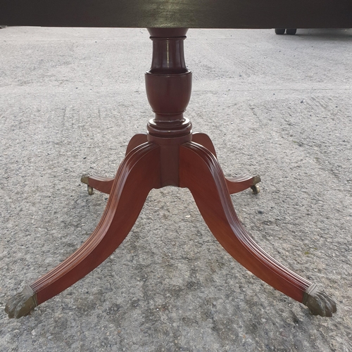 796 - A late 19th Century Mahogany Tilt top Breakfast Table on Brass caster Claw feet.