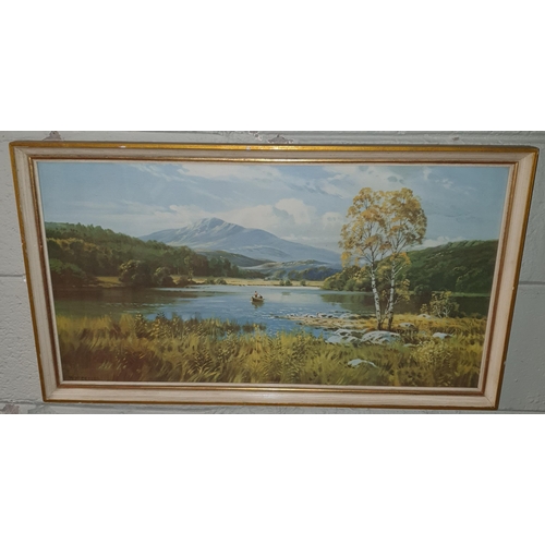 130 - A 20th Century coloured Print of a calm lake scene. 43 x 75 cm approx.