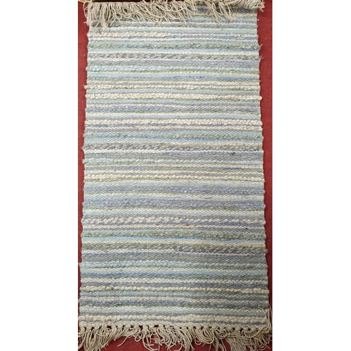 181 - A blue ground Rug.
135 x 68 cm approx.