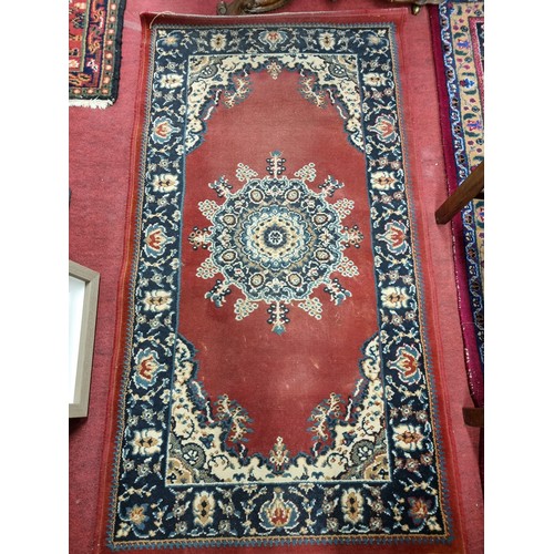 410 - A Red ground Rug. 147 x 80 cm approx.