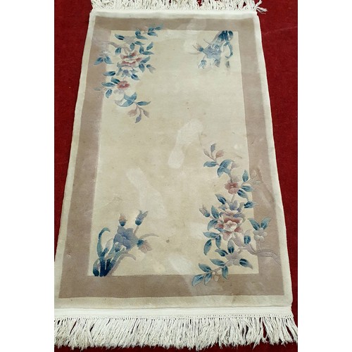 413 - A Cream and Tan Oriental Rug. 
L 178 x W 92 cm approx.