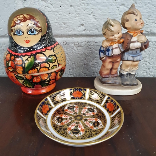 606 - An early Goebel figural group along with a Crown Derby pin dish and a group of Babushka dolls. H 14 ... 