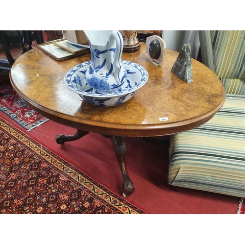 614 - A Victorian Walnut oval Supper Table with a highly veneered butt walnut top on a lovely carved quadr... 