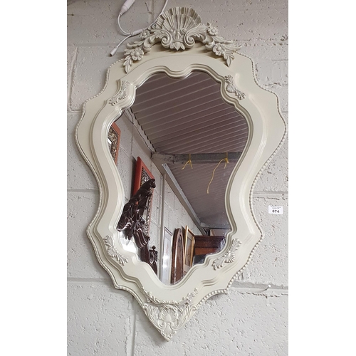 640 - Sold on Behalf of Charity, uncollected Lot.
A good painted Mirror with carved shell top. 90 x 57 cm ... 