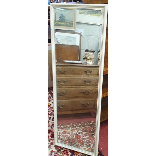 650 - A Rectangular Bevelled Mirror in a white frame.
130 x 44 cm approx.