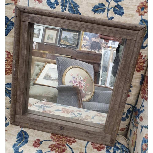 655 - A Square Mirror in a Timber Frame.
47 x 45 cm approx.