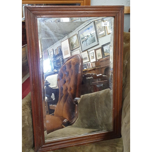 659 - A Rectangular Bevelled Mirror in a timber frame.
70 x 47 cm approx.