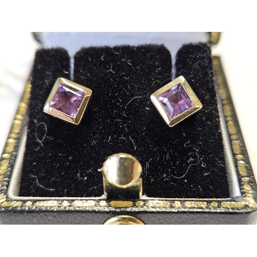 304 - A pair of Gold and Amethyst Earrings.