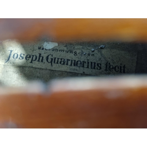 772 - Sold on Behalf of Charity, uncollected Lot.
Joseph Guarnerius fecit. A cased Violin with bow. 19th C... 