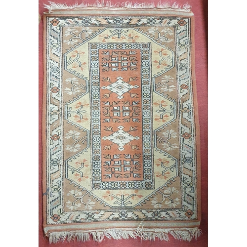 799 - A tan ground Rug.
126 x 86 cm approx.