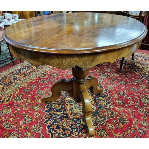 859 - A Victorian Mahogany oval Supper Table on tripod supports with shaped apron. H 74 x 117 x 86 cm appr... 