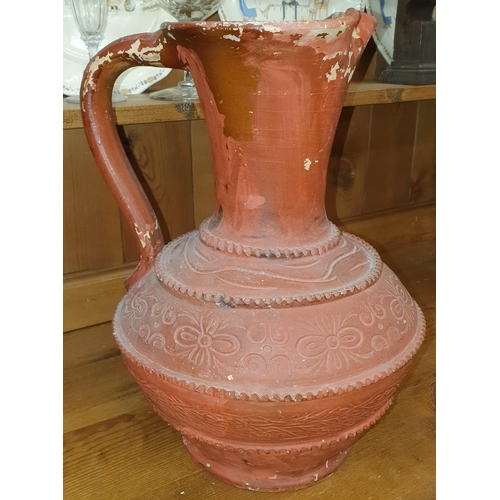 865 - A good early Terracotta Ewer of large size with hand painted decoration. H 38 cm approx.