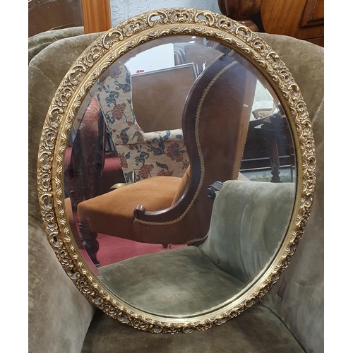 1 - A 20th Century Plaster Gilt oval Mirror with bevelled mirror glass and pierced outline.
57 x 47 cm a... 