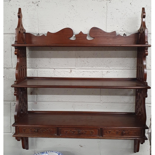 113 - A reproduction Mahogany wall mounted set of Shelves with pierced side outline and triple frieze draw... 