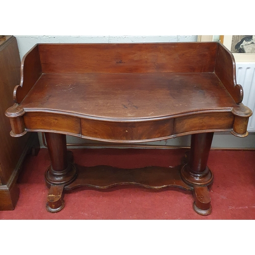 15 - A good early 19th Century Mahogany gallery backed Side Table on turned supports, stretcher base and ... 