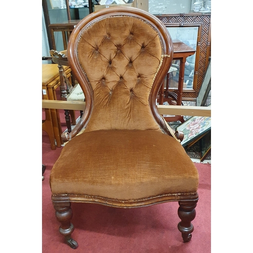 57 - A Victorian Mahogany wingback ladies Salon Chair on turned front supports with brass ceramic castors... 