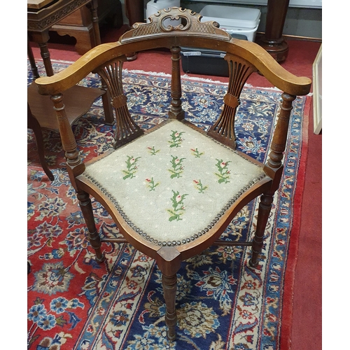 63 - An Edwardian Walnut corner Chair with highly pierced outline with turned front supports and stretche... 