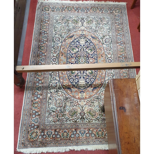 80 - A nice cream ground Rug with multi borders and central medallion design. 122 x 190 cm approx.