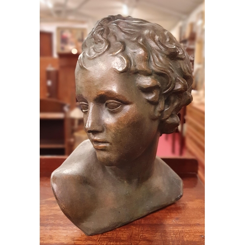 143 - A 20th Century Plaster head and shoulder Bust of a young boy. H 23 cm approx.