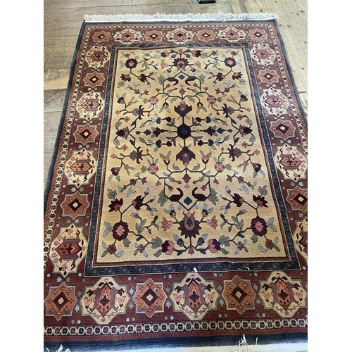 815 - A good brown ground Rug with multi borders and unique medallion design. 240 x 168cm approx.