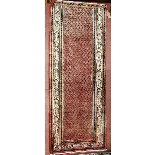 816 - A Persian red ground Runner with multi borders and repeating central design. L 280 x W 114 cm approx... 