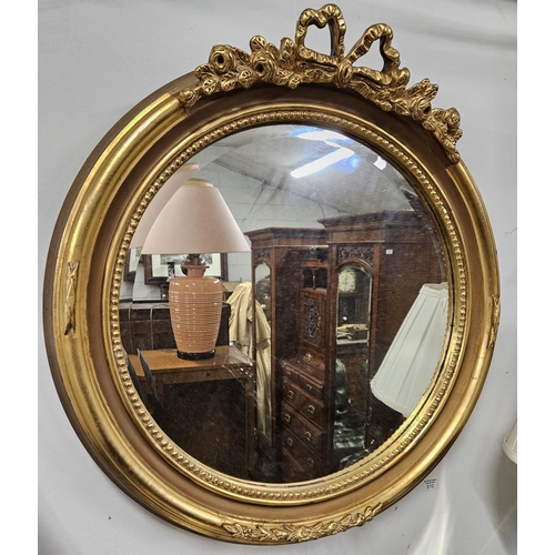 834 - A Timber and Plaster Gilt circular Mirror of neat size with cartouche moulded top. 72 x 70 cm approx... 