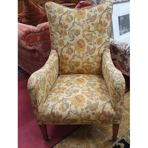 432 - A 19th Century Armchair on square turned tapered supports with brass castors. W 62 x BH 99 cm approx... 