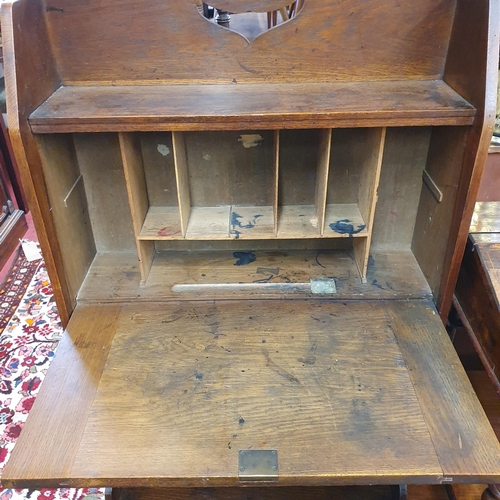 466 - An early 20th Century arts and crafts Oak Bureau with metal strap hinges. W 69 x D 27 x H 125 cm app... 