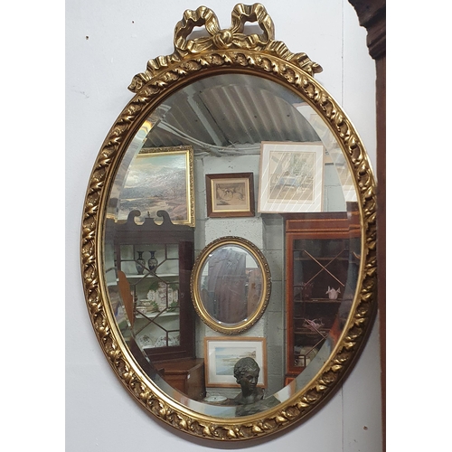 496 - A good early 20th Century oval Mirror with bevelled mirror glass. 56 x 39 cm approx.