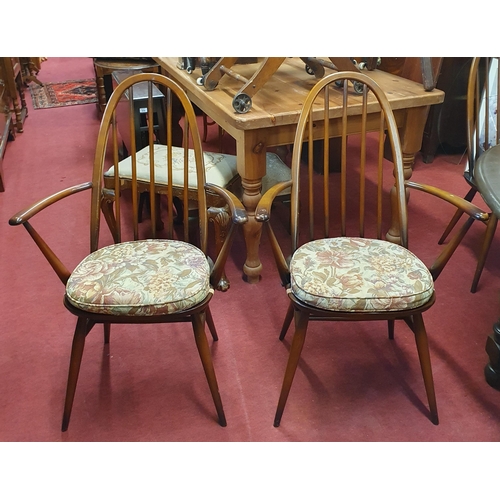 520 - An Ercol dining Table with single leaf and eight Chairs(6+2). (Two bruises to top of the table needs... 