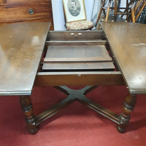 520 - An Ercol dining Table with single leaf and eight Chairs(6+2). (Two bruises to top of the table needs... 