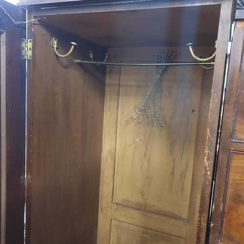 559 - An early 19th Century Mahogany Sentry Box Wardrobe of low size with a central chest flanked by singl... 