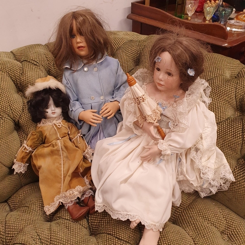 677 - A group of three Porcelain Dolls.