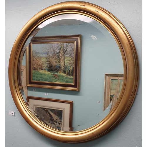 718 - A 20th Century circular Mirror with bevelled glass.
D 58 cm approx.