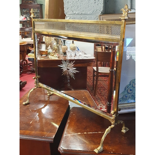 736 - A good early 20th Century Brass Firescreen with mirrored centre. 69 x 60 cm approx.