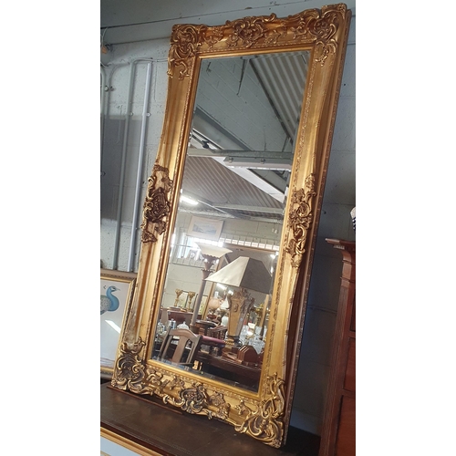 738 - A very large ornate rectangular Plaster Gilt Mirror with bevelled mirror glass. Can be hung both way... 