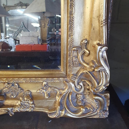 738 - A very large ornate rectangular Plaster Gilt Mirror with bevelled mirror glass. Can be hung both way... 