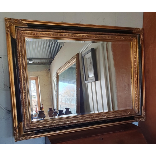 749 - A large rectangular Ebonised and Gilt Mirror with bevelled mirror glass. Can hang both ways. 84 x 11... 