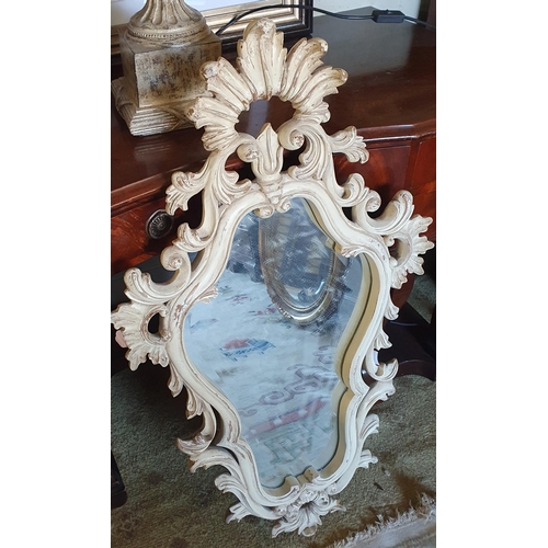 751 - A good Timber Mirror with highly ornate outline.
99 x 58 cm approx.