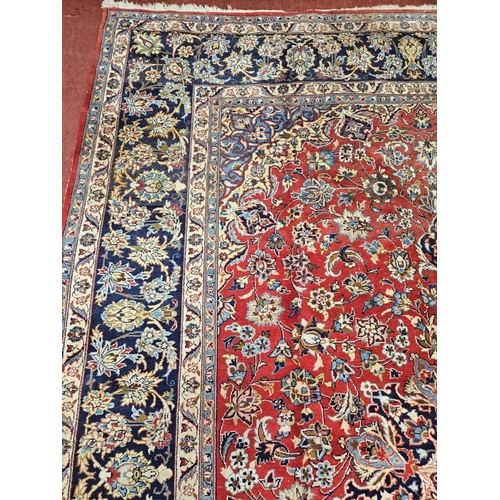 376 - A large Persian red ground Carpet with multi borders and central medallion design 390 x 297cm approx... 