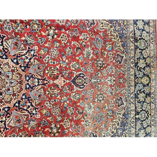 376 - A large Persian red ground Carpet with multi borders and central medallion design 390 x 297cm approx... 