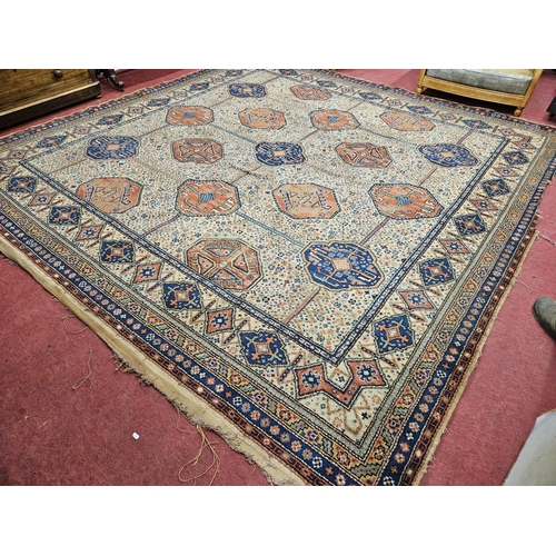 673 - A large cream ground Carpet with multi borders and repeating central pattern design. 325 x 318 cm ap... 