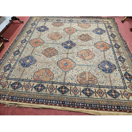 673 - A large cream ground Carpet with multi borders and repeating central pattern design. 325 x 318 cm ap... 