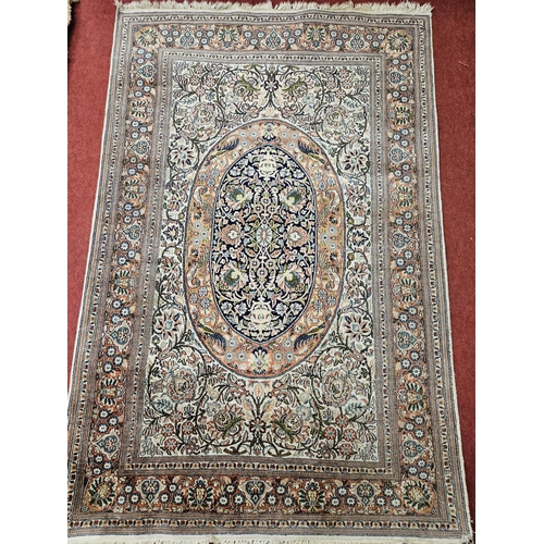 80 - A nice cream ground Rug with multi borders and central medallion design. 122 x 190 cm approx.