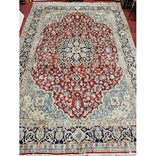 948 - A large Persian Carpet with multi borders and all over decoration with centre medallion design. 265 ... 