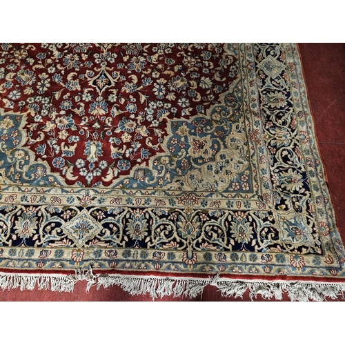 948 - A large Persian Carpet with multi borders and all over decoration with centre medallion design. 265 ... 