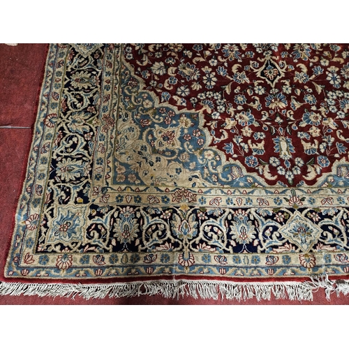 948 - A large Persian Carpet with multi borders and all over decoration with centre medallion design. 265 ... 